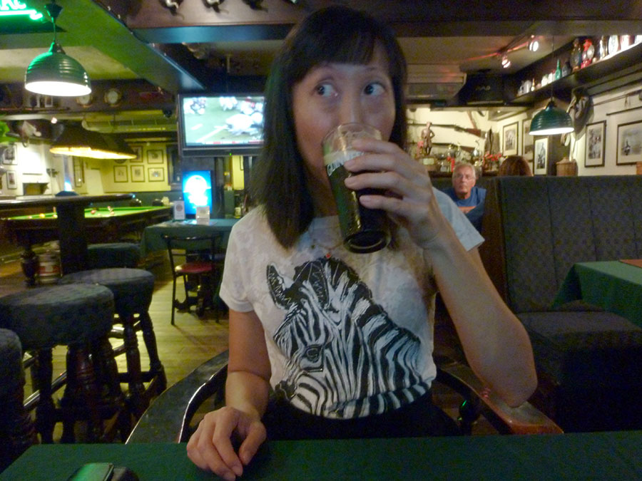 Asian American woman drinking beer