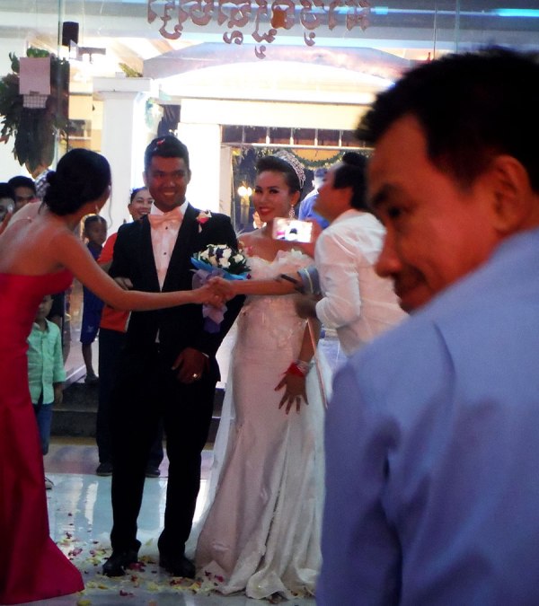Happy groom and bride at Cambodian wedding